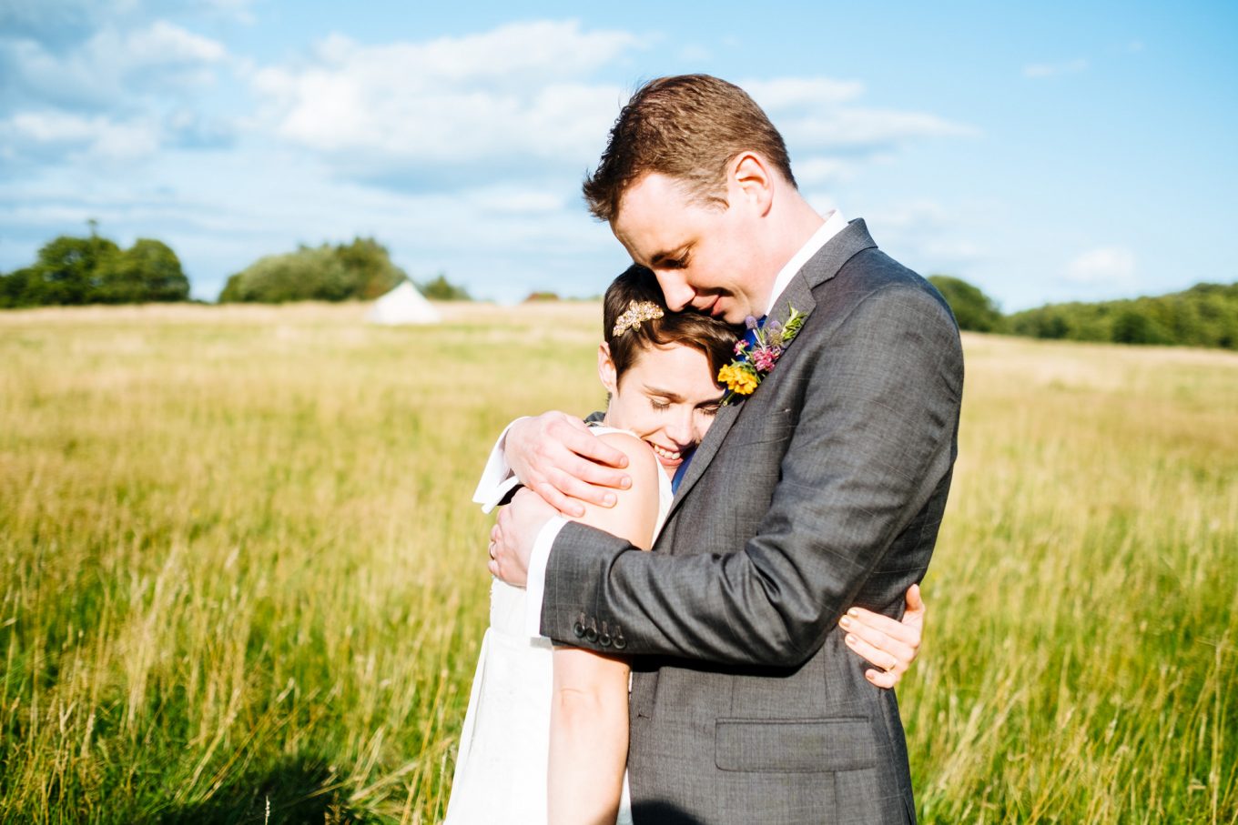bride and groom tight hug