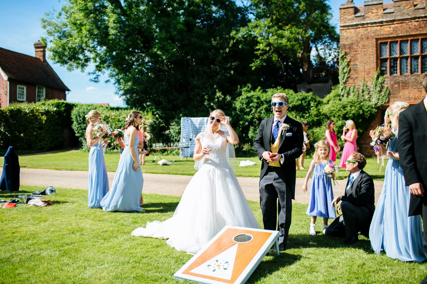 bride and groom playing lawn games in the sun