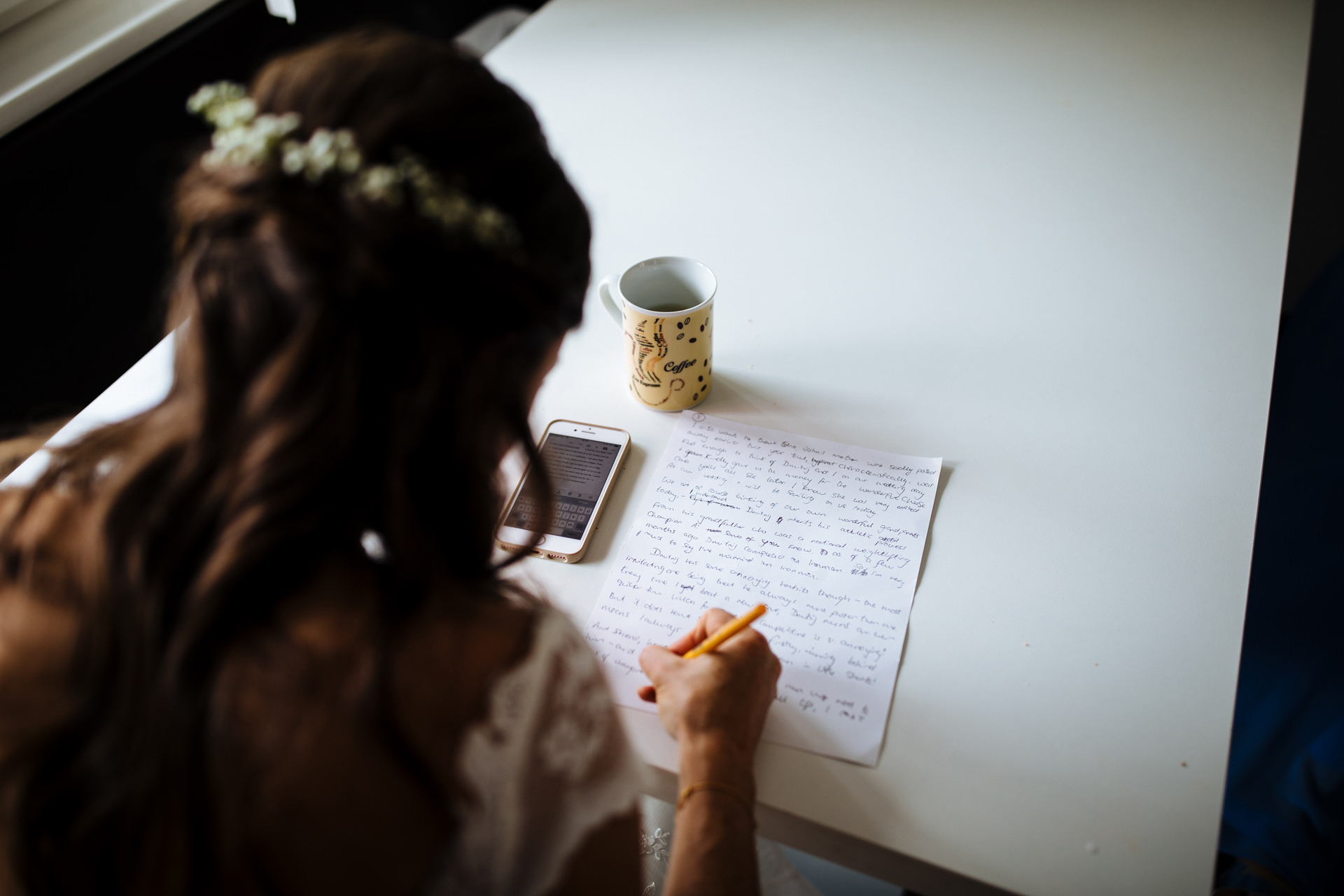 bride writing her speech on wedding morning