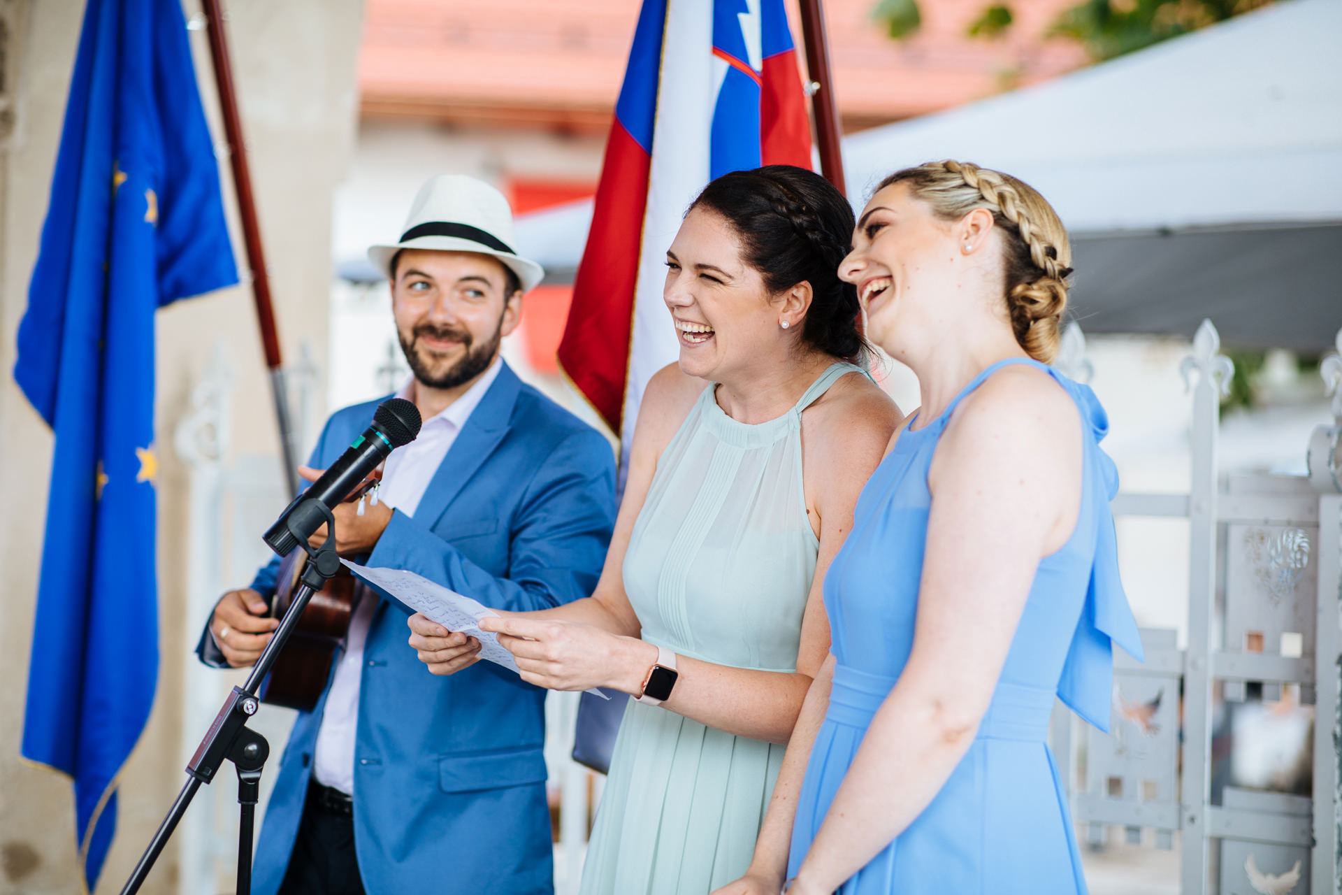 bridesmaids singing a song with wedding guest playing ukulele