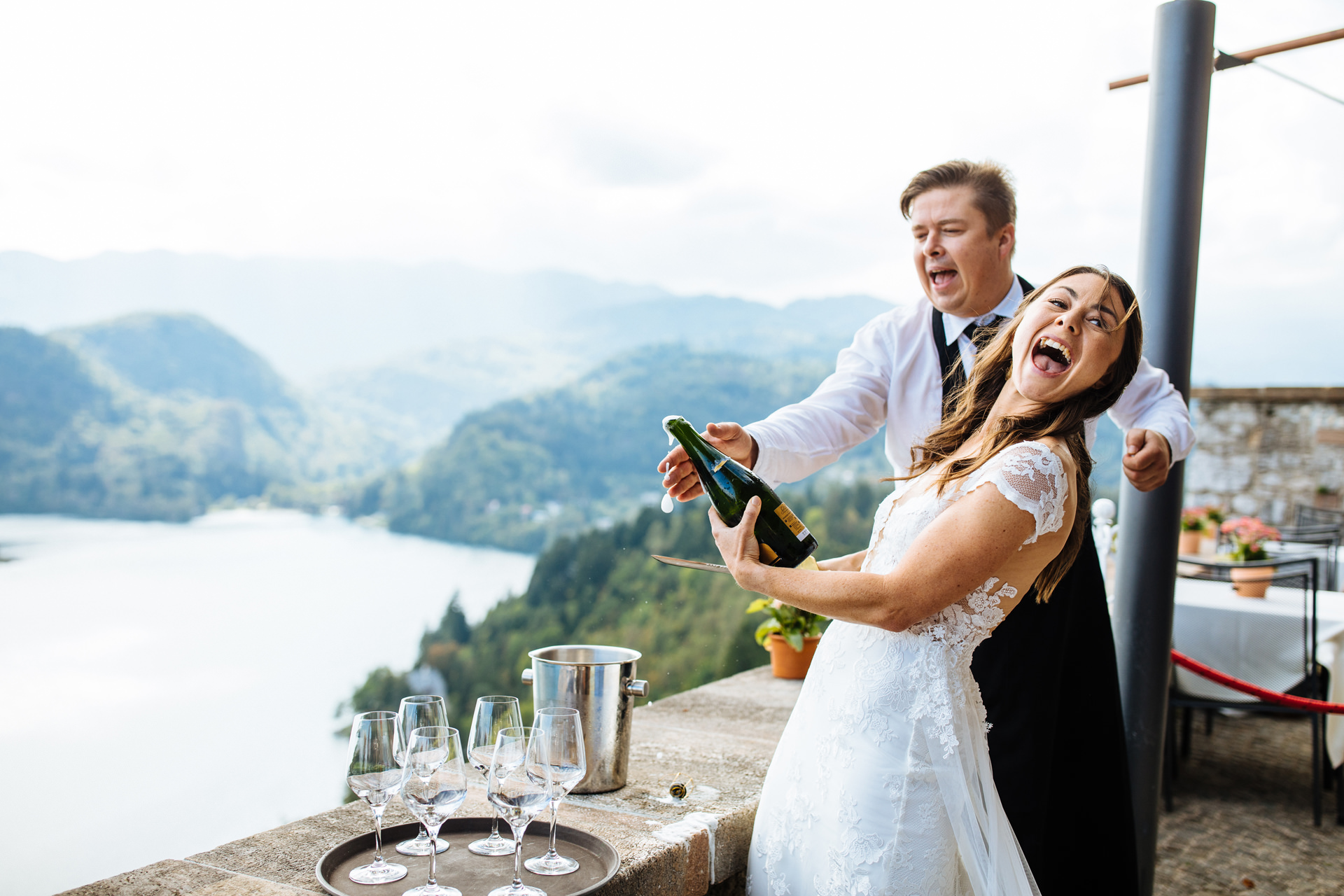 bride slicing open bottle of champagne with knife