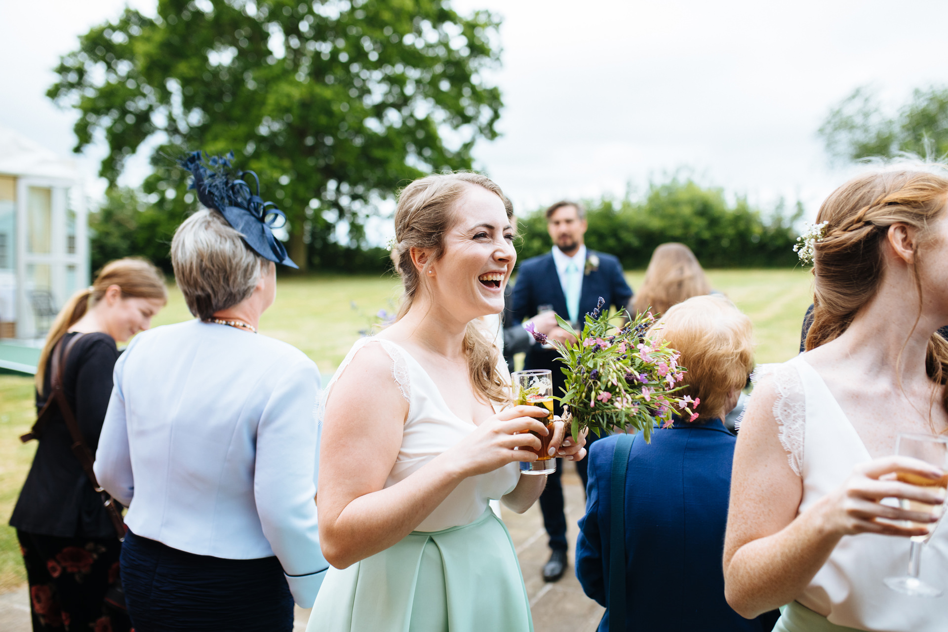 bridesmaid laughing at drinks reception