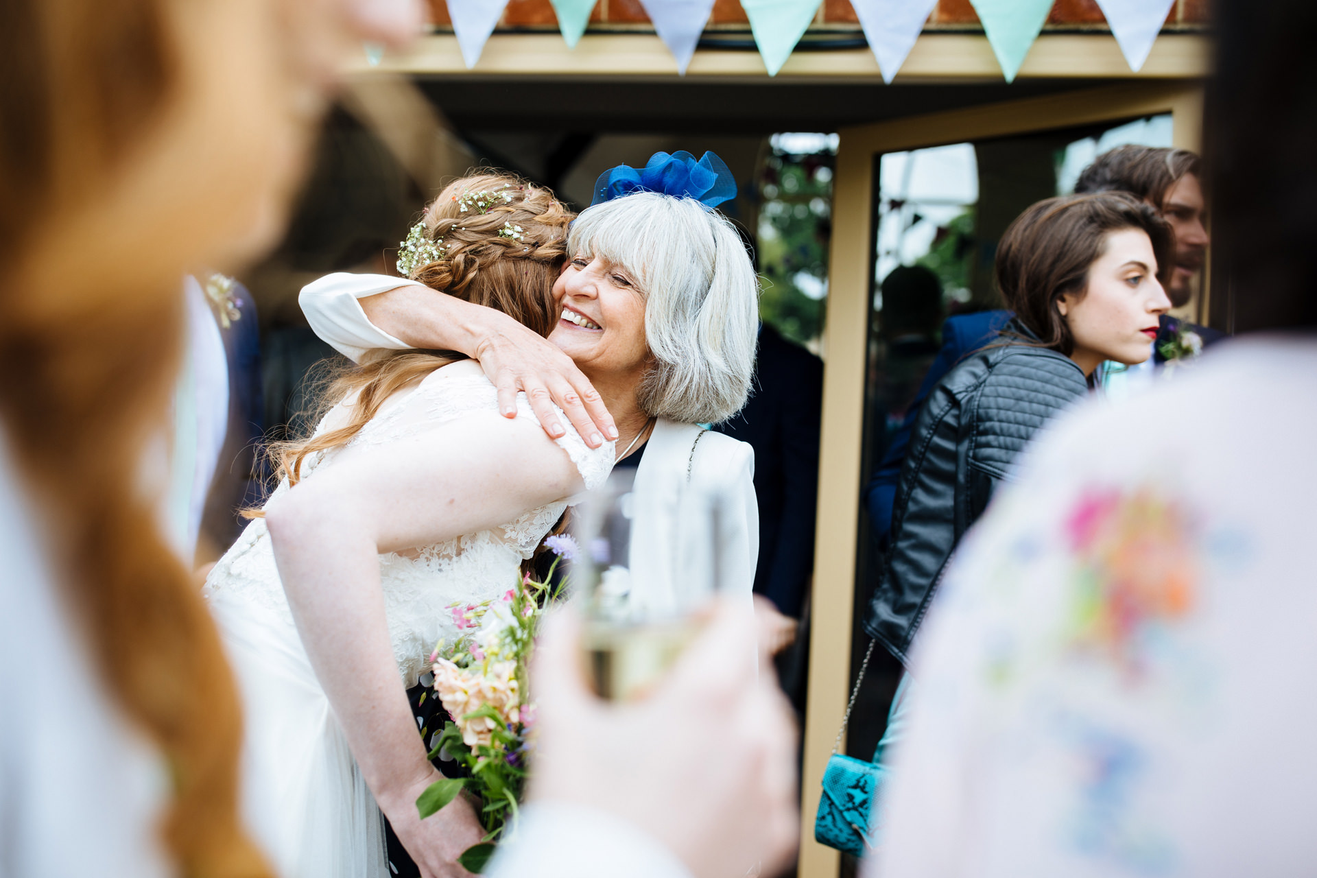 bride and her relative hugging and smiling