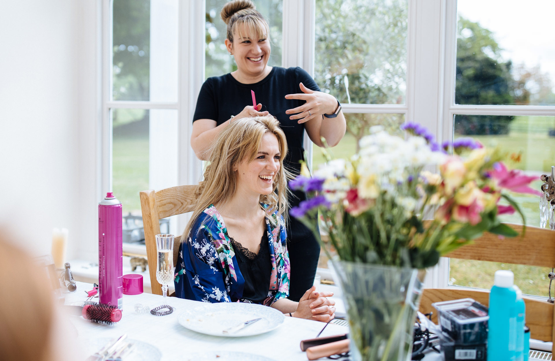 bridesmaid having her hair done during wedding morning