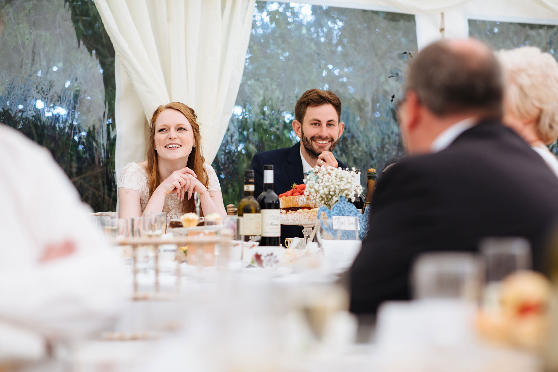 bride and groom reacting to best mans speech