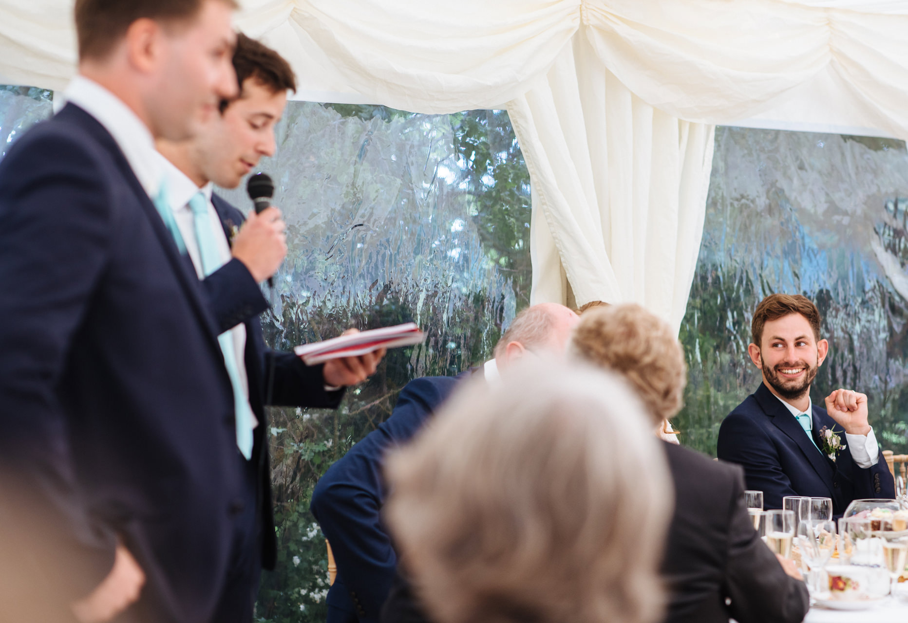 groom laughing at best mans speech