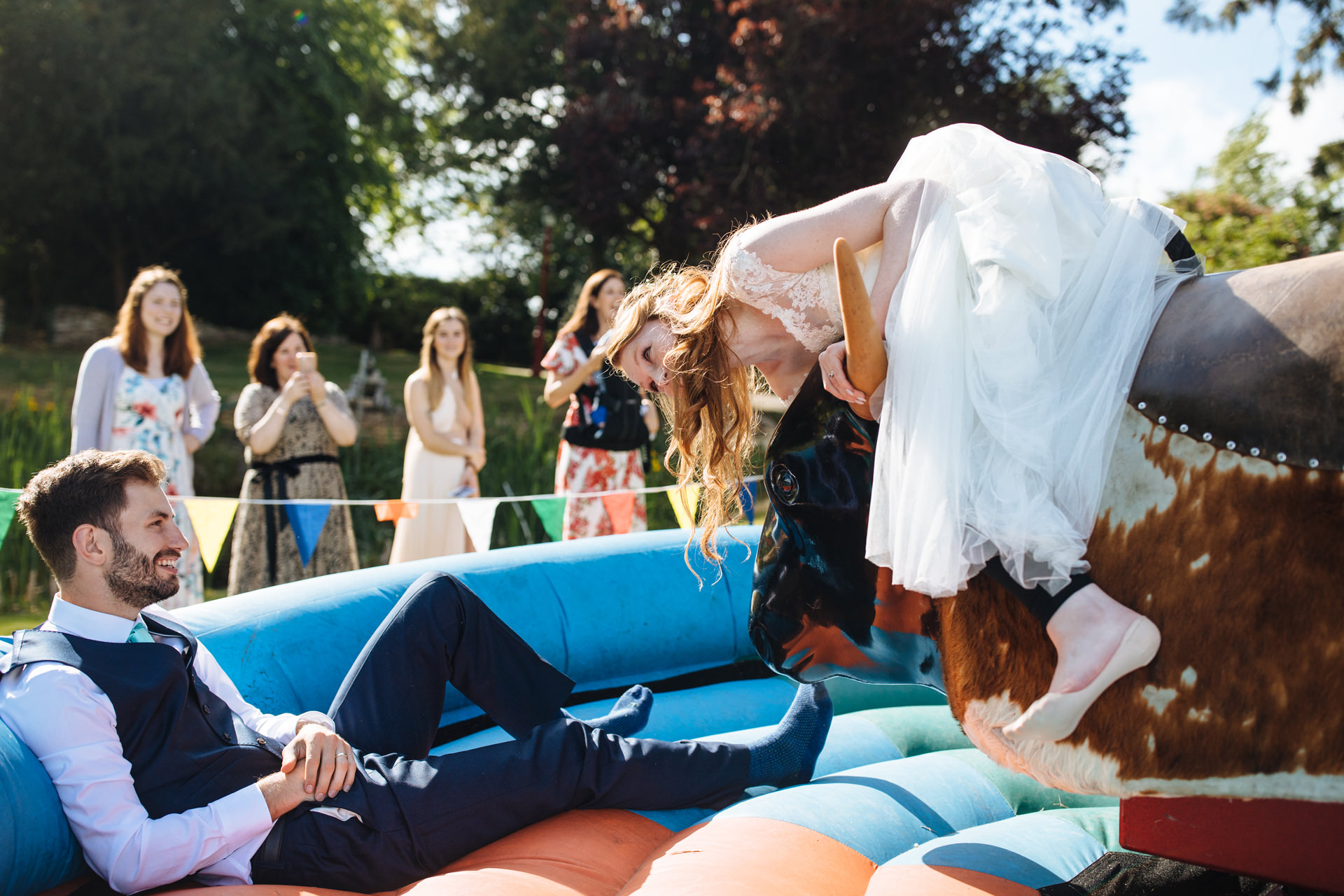 bride and groom on bucking broncho at wedding