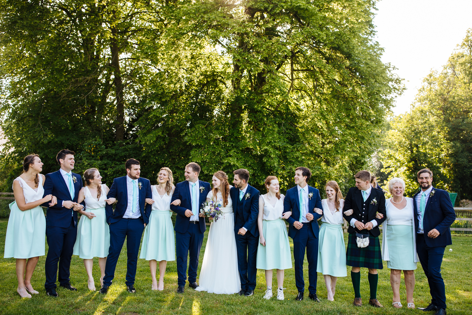 bridal party laughing and having fun at oxfordshire marquee wedding